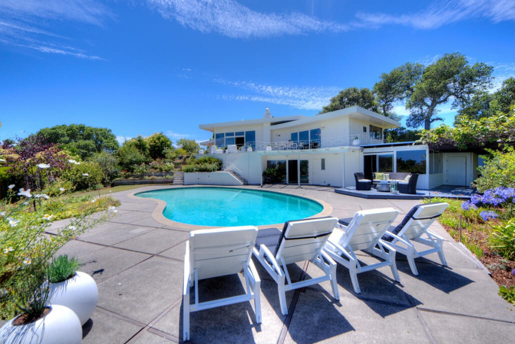 18-013 Pool area with chairs and home in background