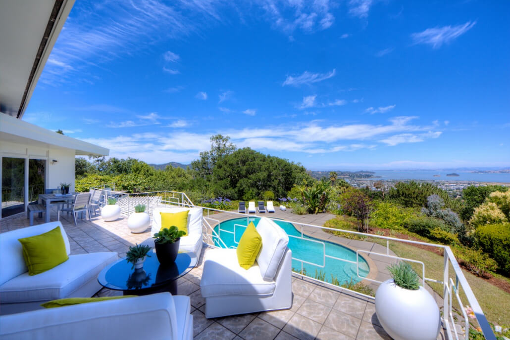 23-018 View of upper deck seating area with pool and bay in background