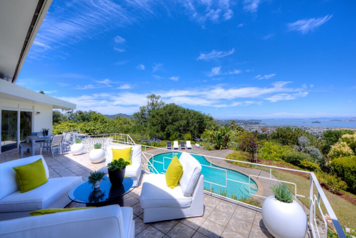 23-018 View of upper deck seating area with pool and bay in background