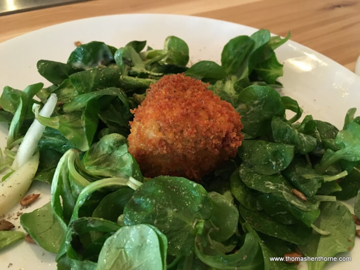 photo of fried camembert over greens