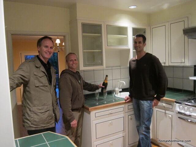 Jim and Mike and Thomas in the kitchen Jim Tyson and Michael Perona with Thomas Henthorne in the dated kitchen of their just-purchased home.