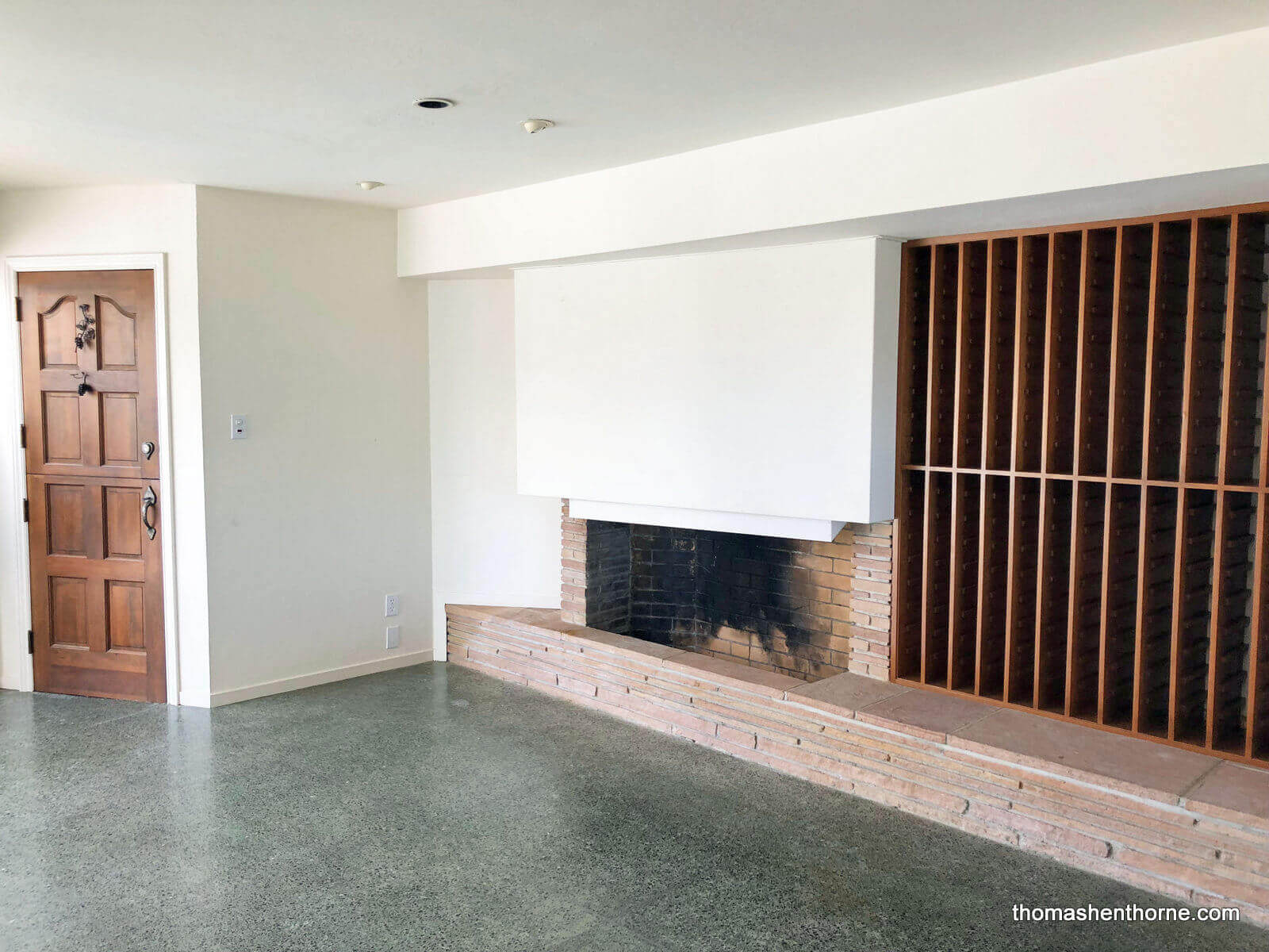 downstairs-den-3 fireplace and wine racls