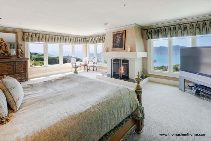 Master bedroom with view of San Francisco Bay and fireplace