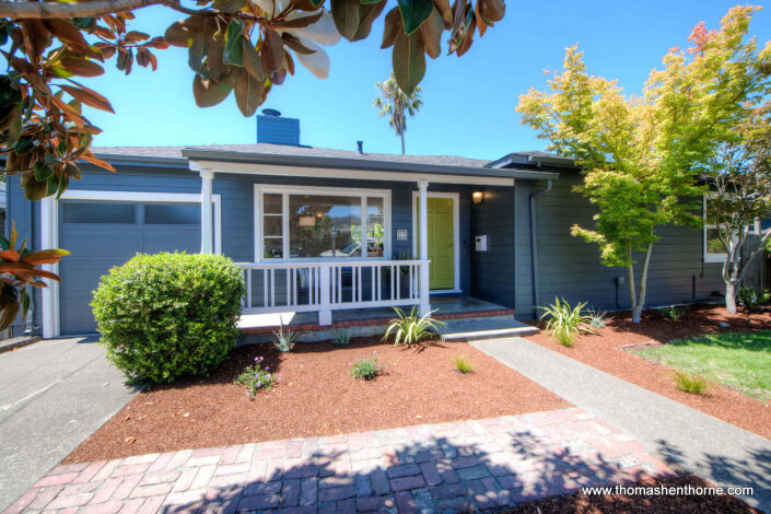 27 Dolores Street San Rafael front view with grey siding and white trim, bright green door