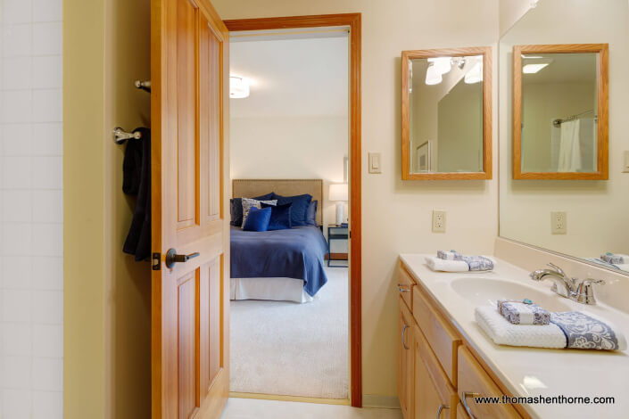 Bathroom looking into bedroom with bed