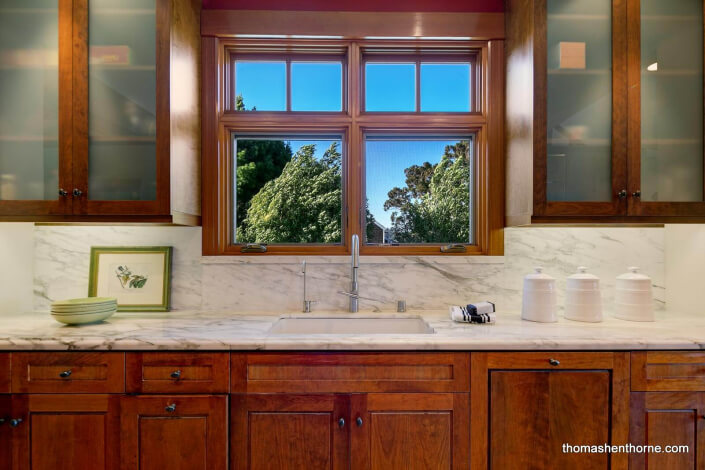 Kitchen with marble countertops and frosted glass cabinets