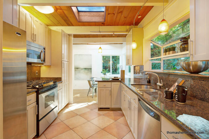 Kitchen with stainless appliances and skylight