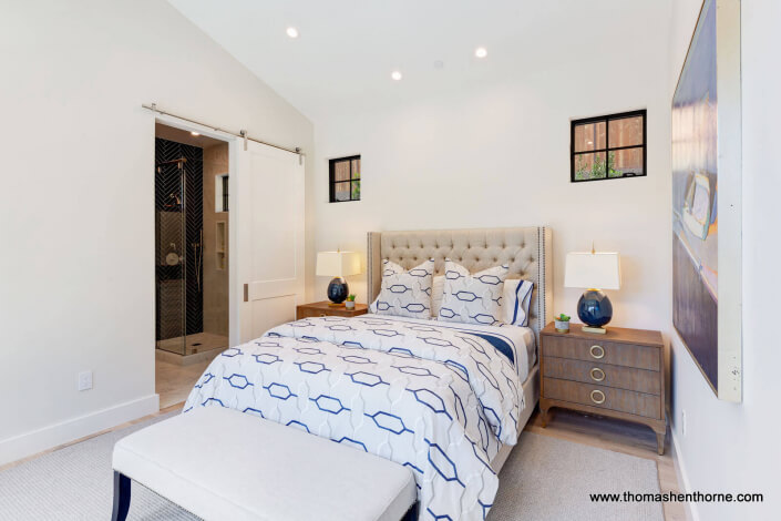 61-Gold-Hill 24 of 83 Bedroom with barn door to bathroom and two windows above bed