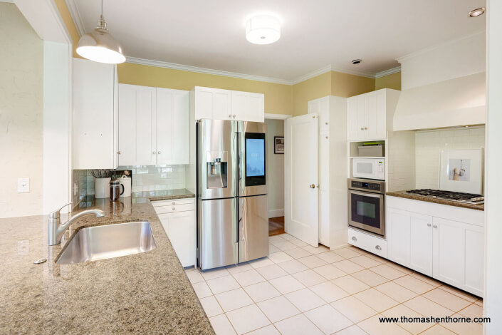 Kitchen with stainless appliances and tile floor