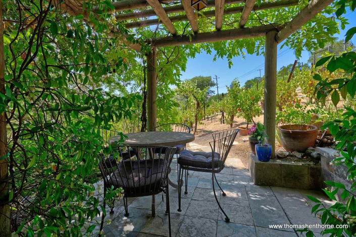 arbor with table and chairs