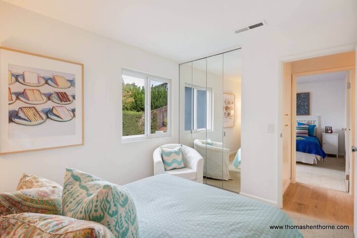 bedroom with mirrored closet door
