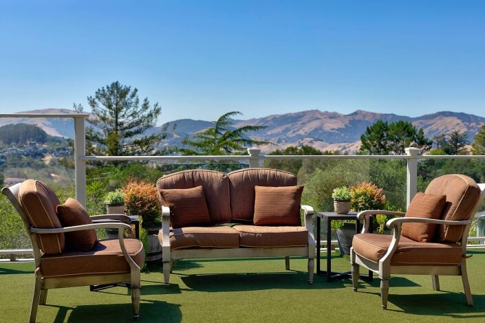patio with chairs and love seat and view