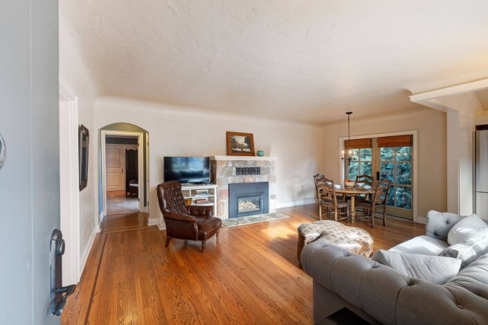 Living room with sofa, chair and fireplace