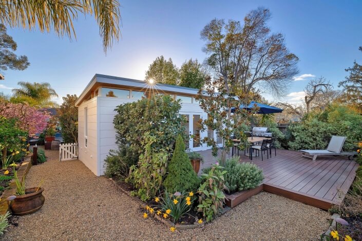 Guest cottage entry with gravel path and wood deck