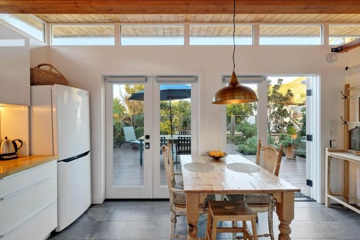 Dining table with view of deck through French doors