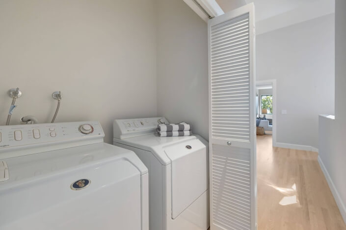 Washer dryer in closet with louvered doors