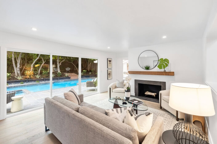 Family room with view of pool and fireplace