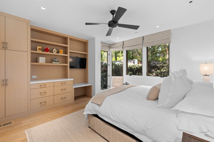 bedroom with built in cabinetry and ceiling fan