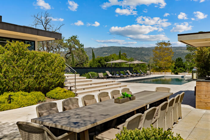 swimming pool area and outdoor dining table