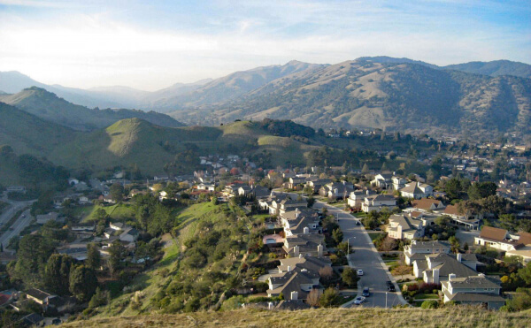 Aerial View of Terra Linda, San Rafael, California showing homes in foreground and Marin hills in background with a hazy sky