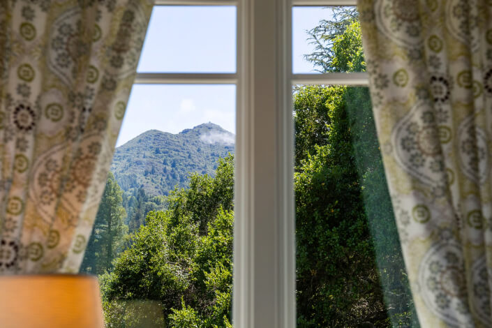 View of Mt. Tamalpais through a window with curtains