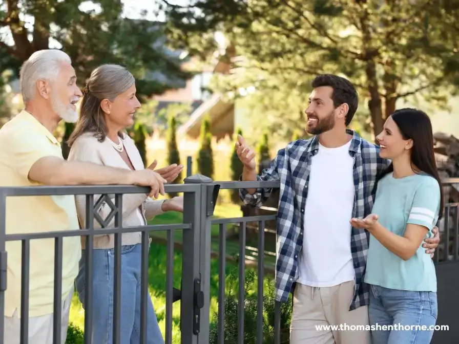 Neighbors talking over a fence